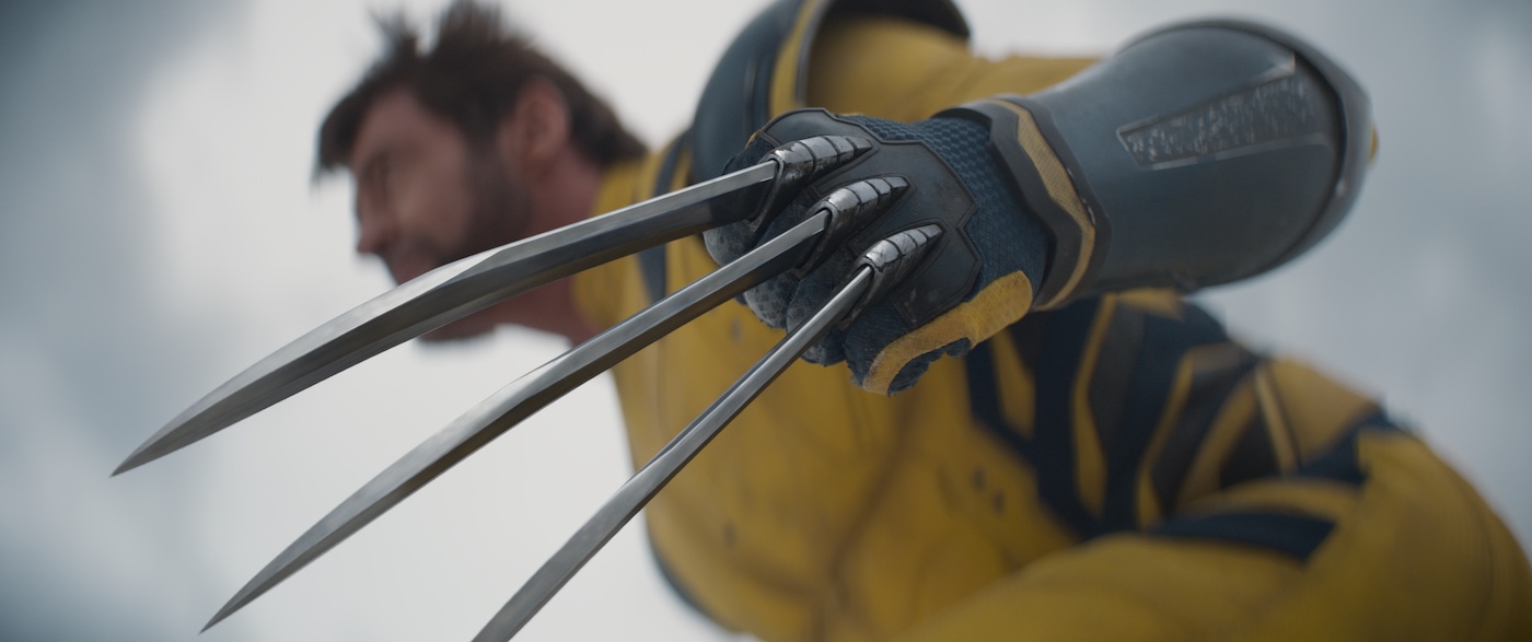 Why Wolverine Steals the Show as Everyone's Favorite X-Man,Image of Wolverine, a muscular mutant with wild hair, mutton chops, and fierce expression, wearing his iconic yellow and blue costume with sharp adamantium claws extended from his fists, ready for battle."